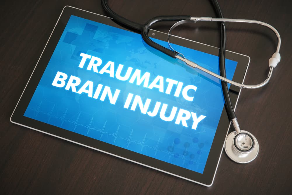 Traumatic brain injury (neurological disorder) diagnosis medical concept on tablet screen with stethoscope.